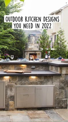 an outdoor kitchen with grills and lights