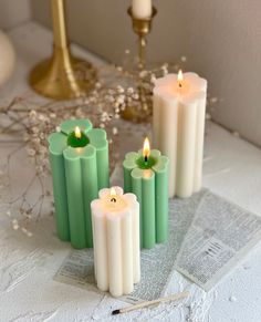 four candles sitting on top of a table