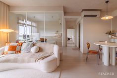 a living room filled with furniture next to a dining table