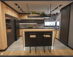 an image of a modern kitchen setting with black appliances and wood flooring on the walls