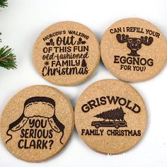 four cork coasters with funny sayings on them next to a christmas tree branch