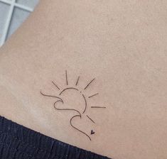 a small sun and heart tattoo on the back of a woman's left arm