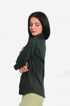 BLUEBIRD WOMEN'S DARK GREEN FORMAL SHIRT  This elegant dark green formal shirt from Bluebird is designed to enhance your professional wardrobe. Crafted with high-quality fabric, it offers both comfort and style, making it a perfect choice for office wear or formal occasions. The tailored fit ensures a flattering silhouette, while the rich color adds a touch of sophistication.  Features  Elegant dark green color  Tailored fit for a flattering silhouette  Comfortable, breathable fabric  Ideal for professional and formal settings   Specifications  Brand: Bluebird  Style: Formal Shirt  Size Options: XS, S, M, L, XL  Closure: Button-down   Material & Care  Material: 100% Cotton  Care Instructions: Machine wash cold, tumble dry low, iron on medium heat  Do not bleach    Legal Disclaimer:  The pr Elegant Green Top For Workwear, Elegant Green Top For Work, Elegant Green Tops For Workwear, Green Fitted Formal Shirt, Green Collared Top For Office, Fitted Green Dress Shirt For Semi-formal Occasions, Fitted Green Shirt For Work, Solid Color Semi-formal Office Shirt, Business Green Long Sleeve Shirt