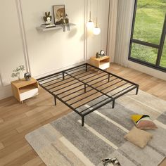 a bed frame sitting on top of a wooden floor next to a window in a bedroom