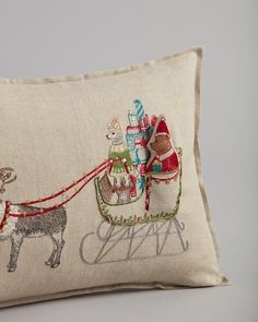 an embroidered pillow with santa's sleigh and reindeer