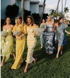 the bridesmaids are walking down the grass together