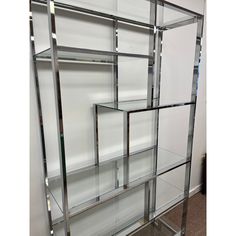 a glass shelf with several shelves in it