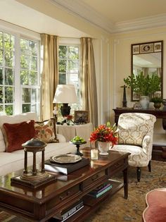 a living room filled with furniture and lots of windows