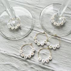 three wine glasses that have some type of earrings on them