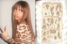 a woman with long hair standing in front of a cake and pointing at the camera