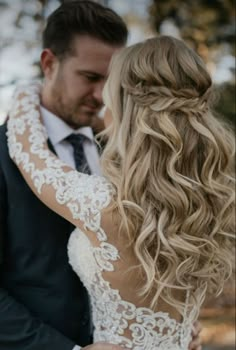 the bride and groom are embracing each other