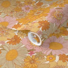 an orange and yellow flowered wallpaper with white trim on the bottom half of it