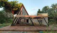 a - frame house with wooden deck and glass walls