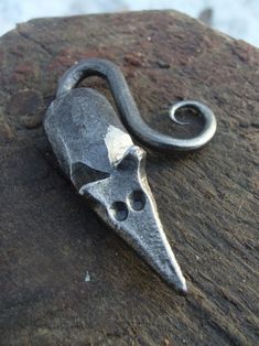 a close up of a metal object on a rock