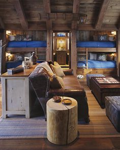 a living room filled with lots of furniture and bunk beds on top of each other