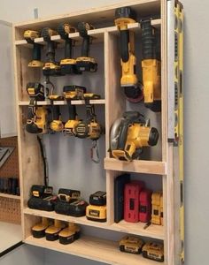 a wooden shelf filled with lots of tools and construction equipment on it's sides