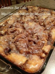 a cinnamon bun cake with icing on top in a pan, ready to be eaten