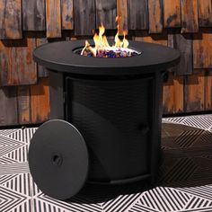 a black fire pit sitting on top of a tiled floor