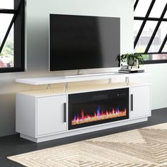 an entertainment center with a television and fireplace