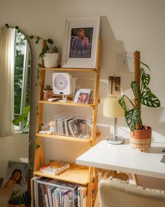 there is a book shelf with books on it in the corner next to a window