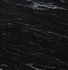 a black marble textured surface with white streaks on the top and bottom, as seen from above