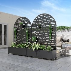 two planters with plants in them on a patio