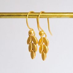 18K Gold Plated Braided Wheat Earrings These retro wheat leaf earrings are handcrafted with recycled and 18K gold plated sterling silver. They symbolize fertility and peace. The leaves are slightly and individually moving and as you move these light earrings will sway softly. In the creation of this earrings I was inspired by the vintage style of the 1990s and also aimed to create a perfect gift a Virgo sign. In Idilius Jewelry, each item is handcrafted by me in my Istanbul studio. Since I use traditional jewelry-making techniques, my production process does not involve machines or 3d modeling. Each leaf is filed, sanded, and assembled together, and comes with a brushed finish. Nowadays, we live in the very heart of a consumer society and have a huge negative impact on the environment and Light Earrings, Traditional Jewelry, Recycled Sterling Silver, Zipper Bags, Leaf Earrings, Gold Plated Sterling Silver, Flower Earrings, Vintage Stil, Style Vintage