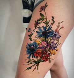 a woman's thigh with flowers painted on it