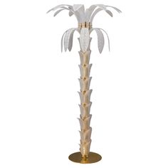 a tall white and gold palm tree on a stand