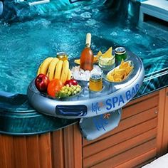 a hot tub filled with lots of food and drinks