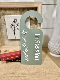 a green door hanger sitting on top of a wooden table