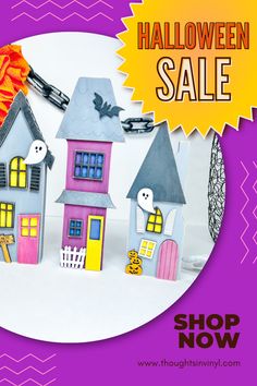 a halloween sale with paper houses and pumpkins on the front, along with a purple background