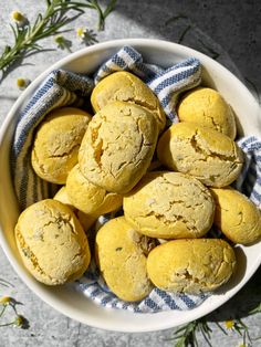 a white bowl filled with cookies on top of a blue and white towel