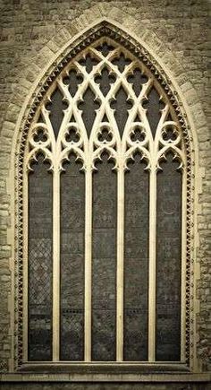 an old church window with iron bars on it