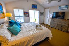 a bedroom with a bed, dresser and television