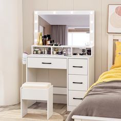 a bedroom with a white vanity and yellow pillows