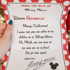 someone is holding up a letter to mickey mouse