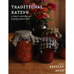 the cover of traditional eating, featuring jars of pickles and jams on a table with flowers in the background