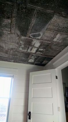 the ceiling in this room has been stripped off and painted black with white paint on it