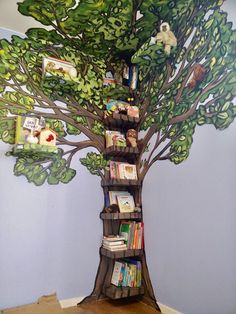 a tree with bookshelves and pictures on it