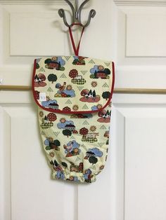 an oven mitt hanging from a hook on a door