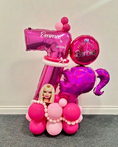 a pink and purple number one balloon bouquet with balloons in the shape of a hairdryer