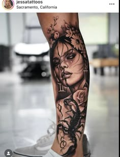 a woman's leg with tattoos on it