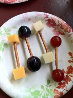 fruit and cheese skewers are arranged on a plate