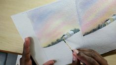 someone is painting some pictures with watercolors on paper