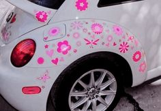 a white car with pink flowers painted on it