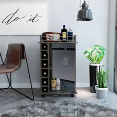 a room with a chair, wine rack and potted plant