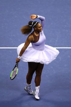 a female tennis player is holding her racket in one hand and looking up at the sky