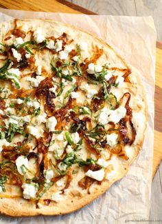 a pizza sitting on top of a wooden cutting board