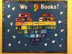 a bulletin board with many books arranged in the shape of a heart and words reading we love books